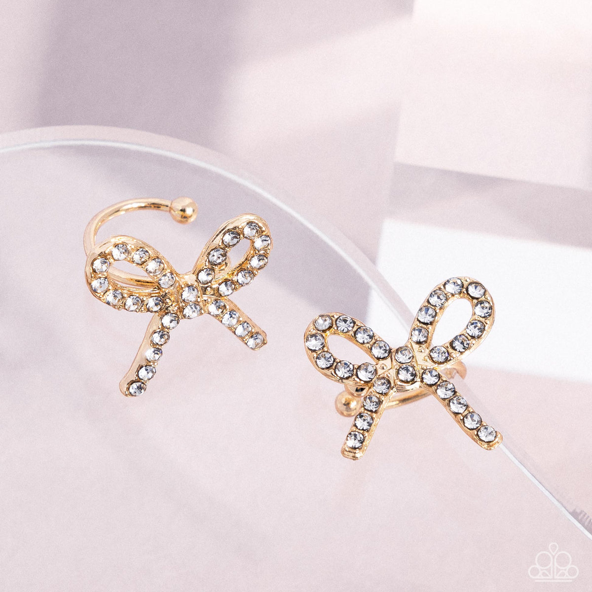 Convincing Charm Gold & White Rhinestone Bow Ear Cuffs - Paparazzi Accessories