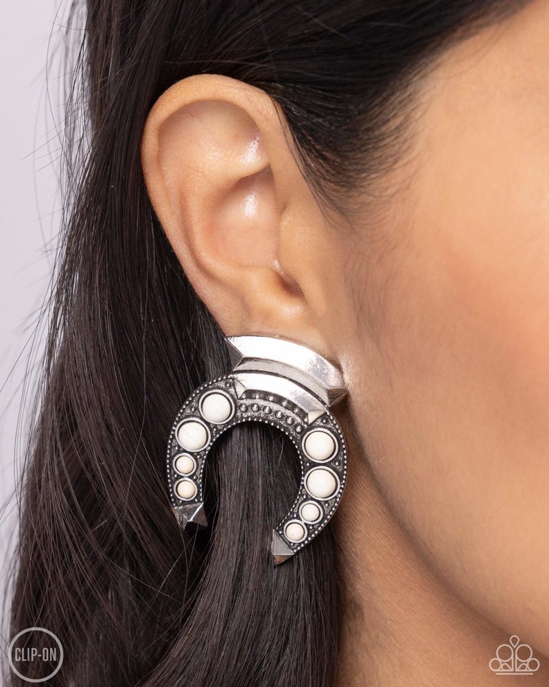 Harmonious Horseshoe White Clip-on Earrings - Paparazzi Accessories- on model - CarasShop.com - Paparazzi Jewelry by Cara Jewels