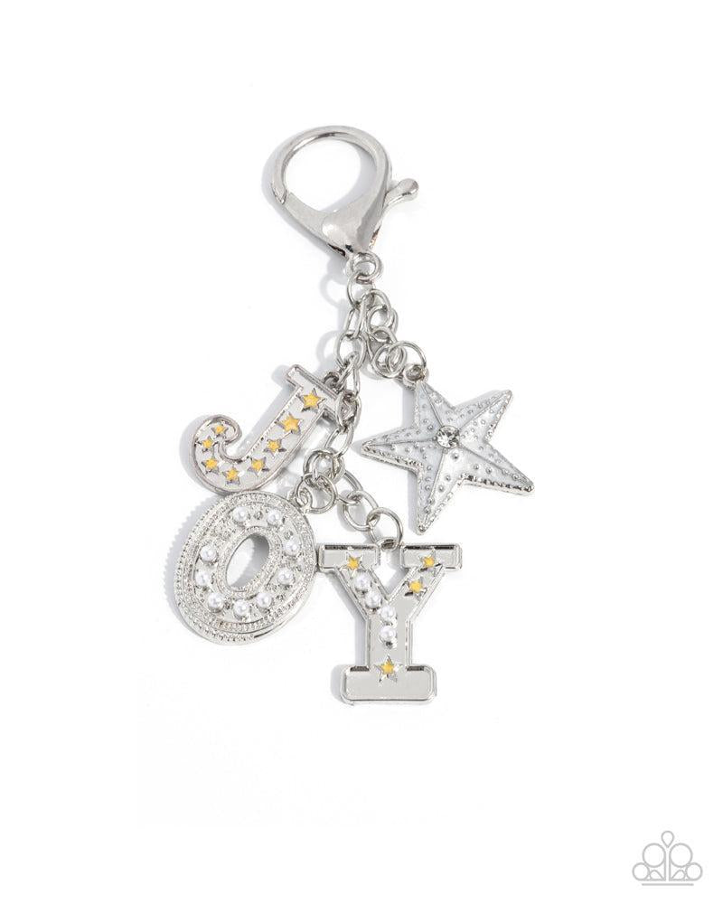 Make a Joyful Noise Multi Silver & White Bag Charm - Paparazzi Accessories- lightbox - CarasShop.com - Paparazzi Jewelry by Cara Jewels