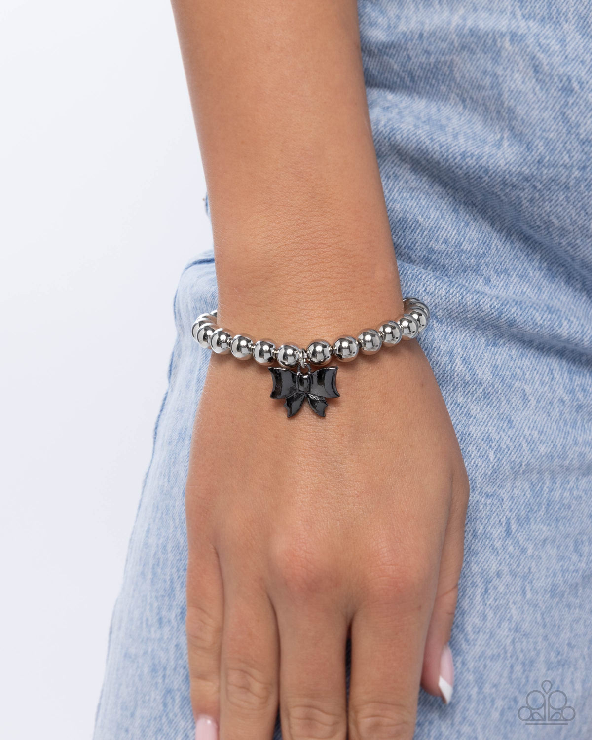 Young Lady Black & Silver Bow Bracelet - Paparazzi Accessories- on model - CarasShop.com - Paparazzi Jewelry by Cara Jewels
