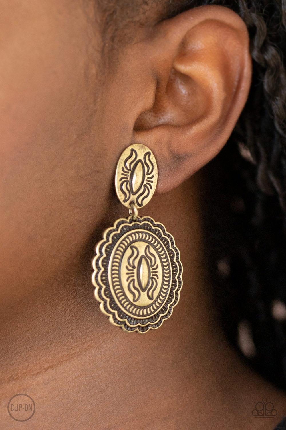 Ageless Artifact Brass Clip-On Earrings - Paparazzi Accessories- on model - CarasShop.com - Paparazzi Jewelry by Cara Jewels