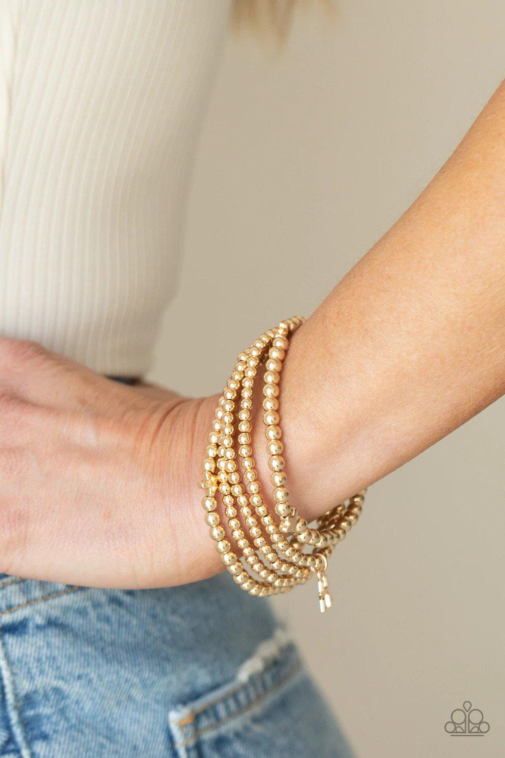American All-Star Gold Bracelet - Paparazzi Accessories- on model - CarasShop.com - Paparazzi Jewelry by Cara Jewels