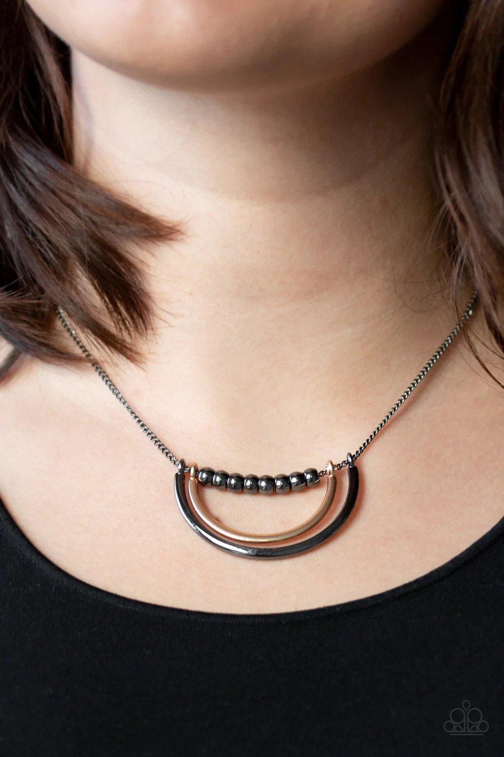 Artificial Arches Gunmetal Black & Gold Necklace - Paparazzi Accessories- on model - CarasShop.com - Paparazzi Jewelry by Cara Jewels