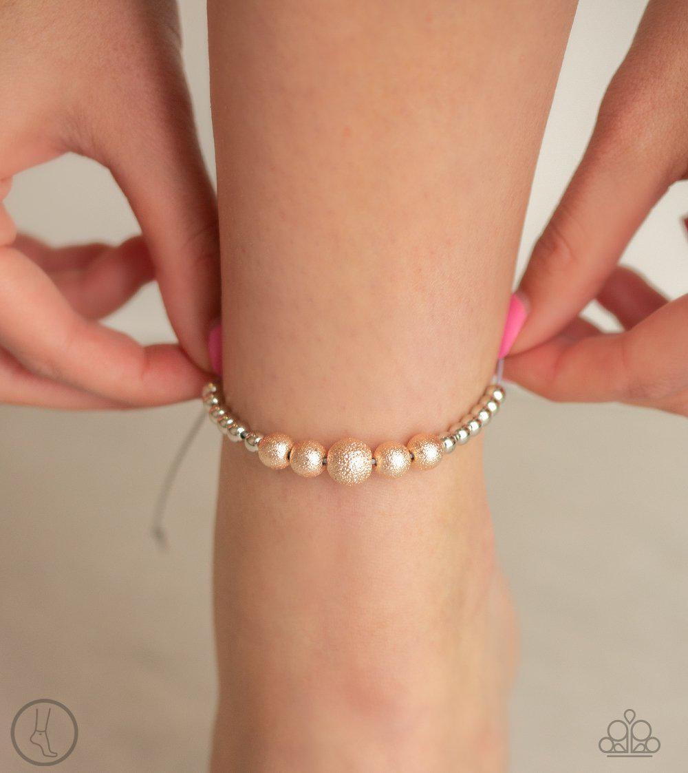 Beach Zen Multi Silver and Rose Gold Sliding Knot Anklet - Paparazzi Accessories- on model - CarasShop.com - Paparazzi Jewelry by Cara Jewels