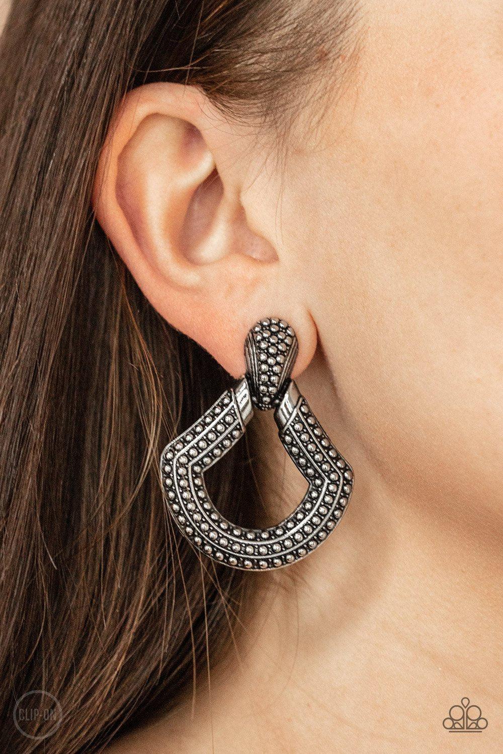 Better Buckle Up Silver Clip-on Earrings - Paparazzi Accessories- on model - CarasShop.com - Paparazzi Jewelry by Cara Jewels