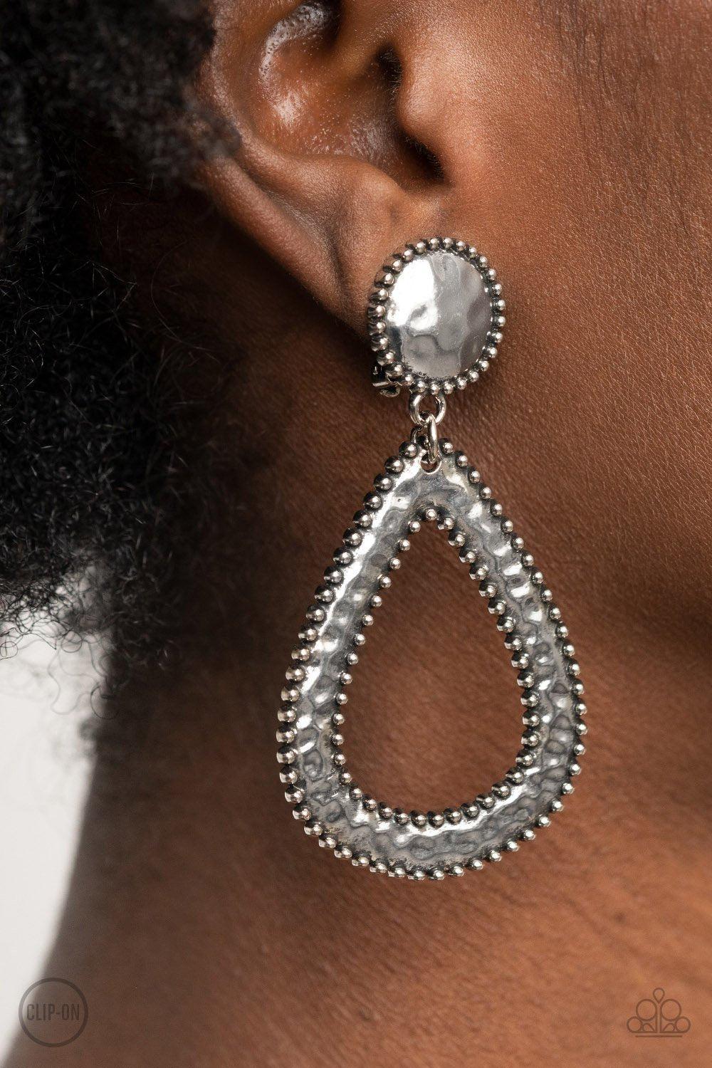 Beyond The Borders Silver Clip-on Earrings - Paparazzi Accessories- on model - CarasShop.com - Paparazzi Jewelry by Cara Jewels