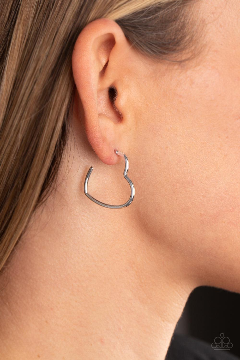 Burnished Beau Silver Heart Hoop Earrings - Paparazzi Accessories- on model - CarasShop.com - Paparazzi Jewelry by Cara Jewels