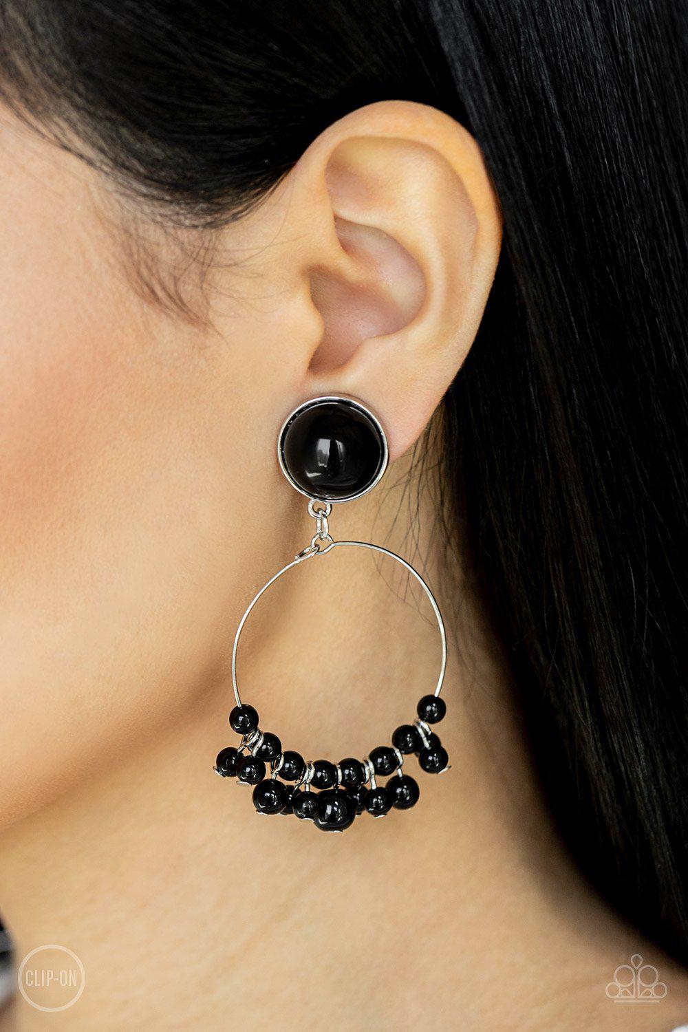 Cabaret Charm Black Clip-On Earrings - Paparazzi Accessories- on model - CarasShop.com - Paparazzi Jewelry by Cara Jewels