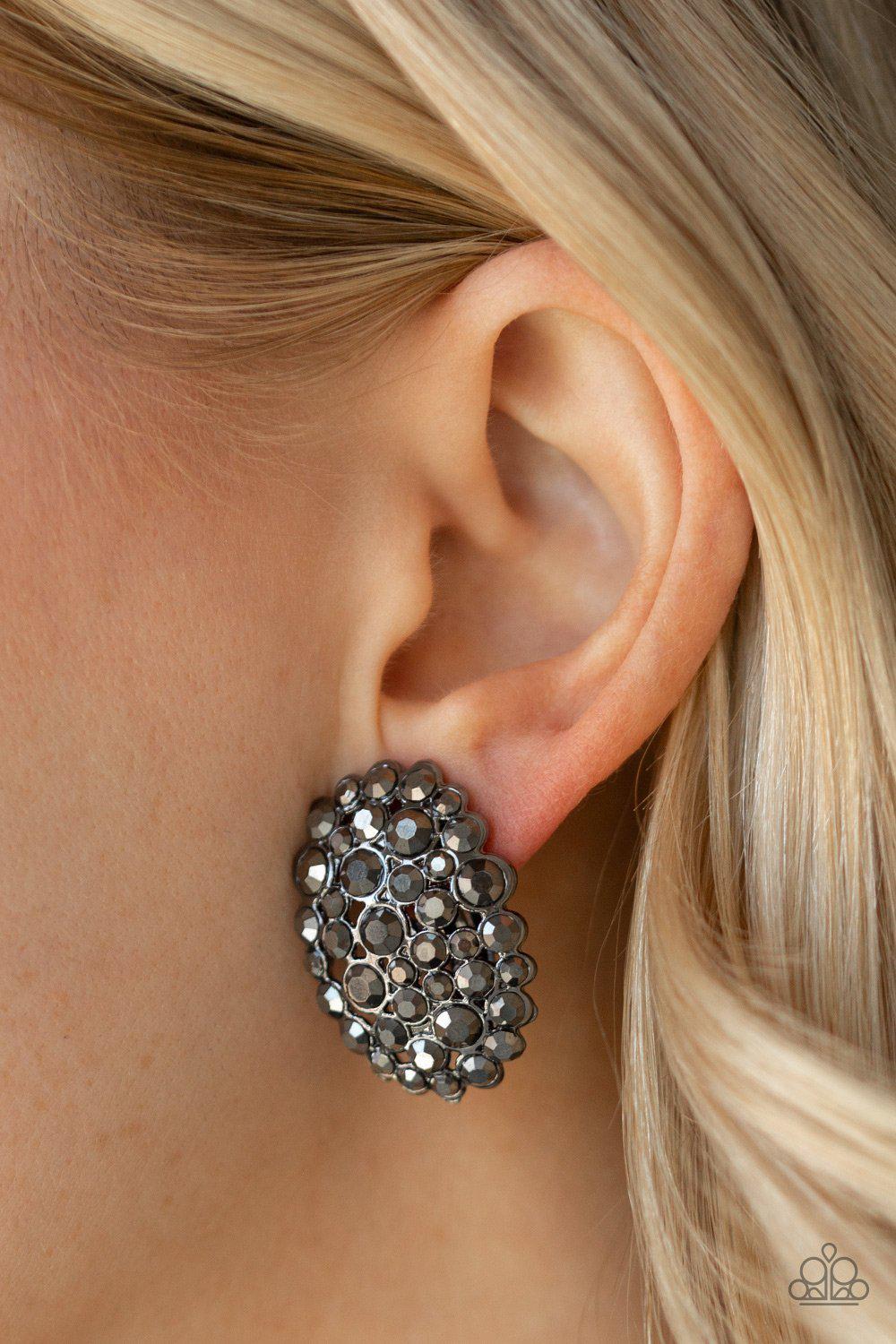 Daring Dazzle Gunmetal Black Clip On Earrings - Paparazzi Accessories- on model - CarasShop.com - Paparazzi Jewelry by Cara Jewels