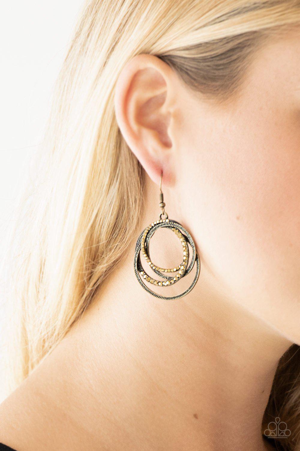 Elegantly Entangled Brass and Rhinestone Earrings - Paparazzi Accessories- on model - CarasShop.com - Paparazzi Jewelry by Cara Jewels