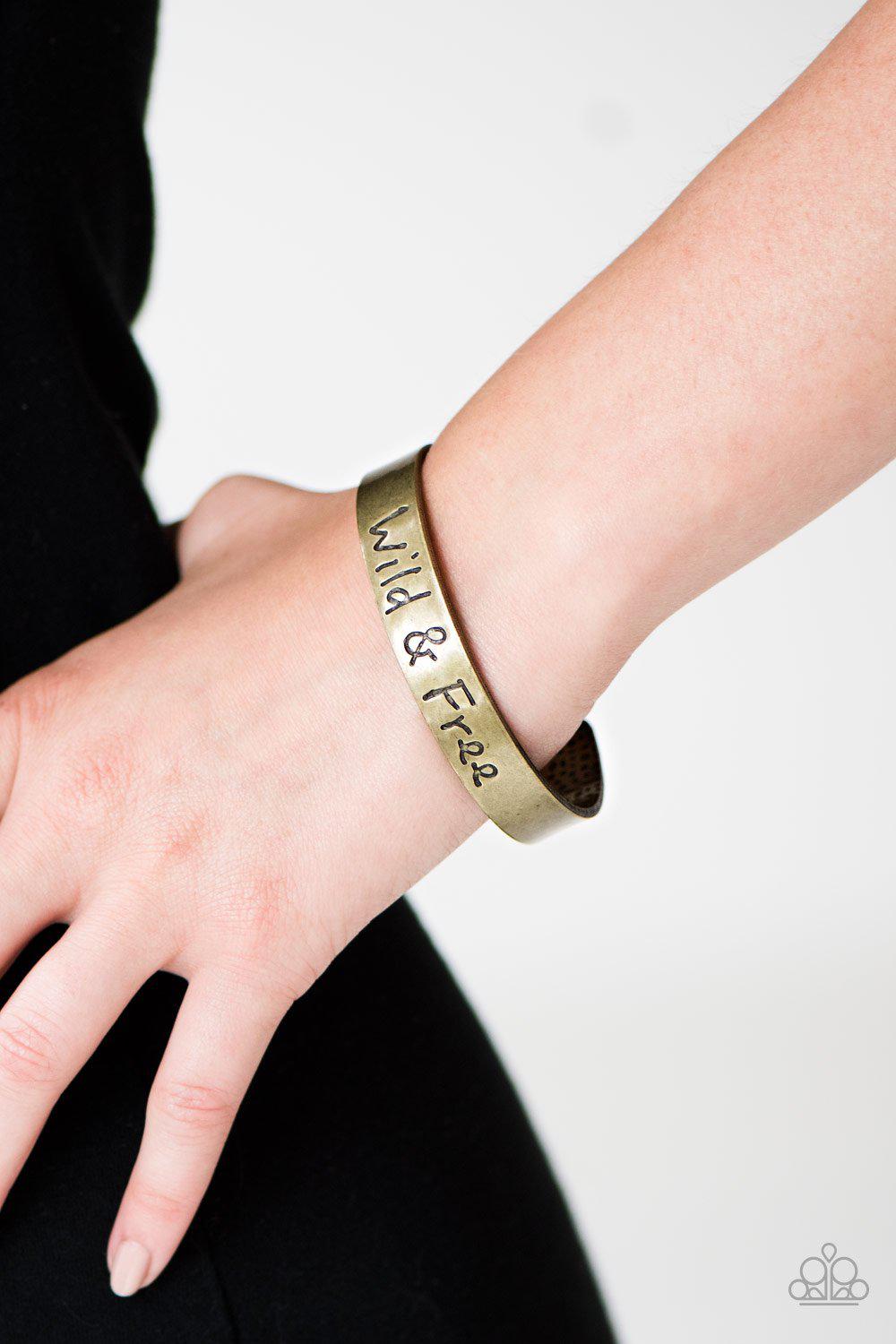 Free To Be Wild Brass Inspirational Cuff Bracelet - Paparazzi Accessories- on model - CarasShop.com - Paparazzi Jewelry by Cara Jewels