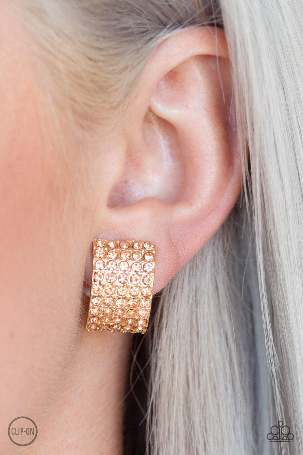 Hollywood Hotshot Gold Rhinestone Clip-on Earrings - Paparazzi Accessories- on model - CarasShop.com - Paparazzi Jewelry by Cara Jewels