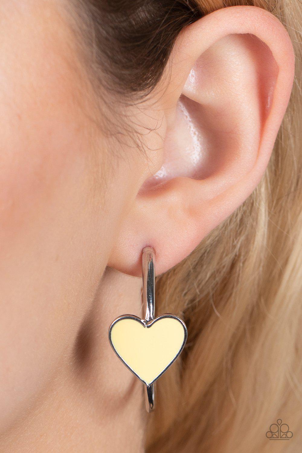 Kiss Up Yellow and Silver Heart Hoop Earrings - Paparazzi Accessories- on model - CarasShop.com - Paparazzi Jewelry by Cara Jewels