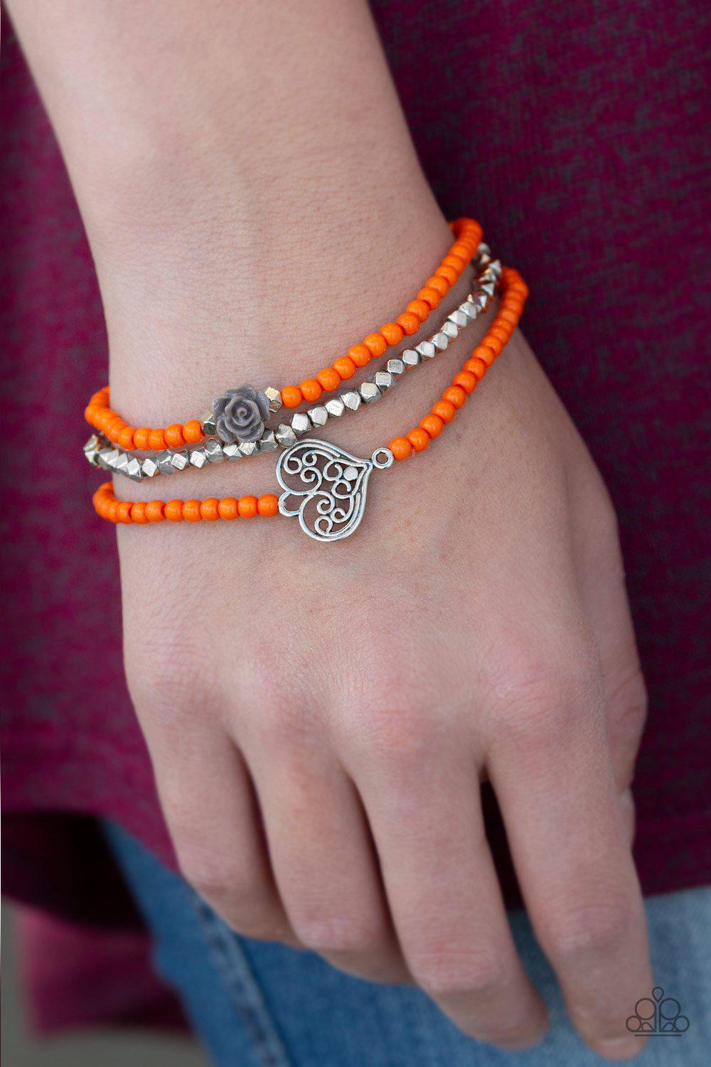 Lovers Loot Orange and Silver Bracelet Set - Paparazzi Accessories- on model - CarasShop.com - Paparazzi Jewelry by Cara Jewels