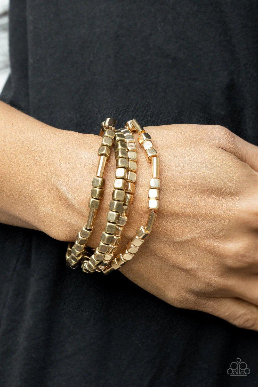 Metro Materials Multi Gold and Brass Bracelet Set - Paparazzi Accessories- on model - CarasShop.com - Paparazzi Jewelry by Cara Jewels