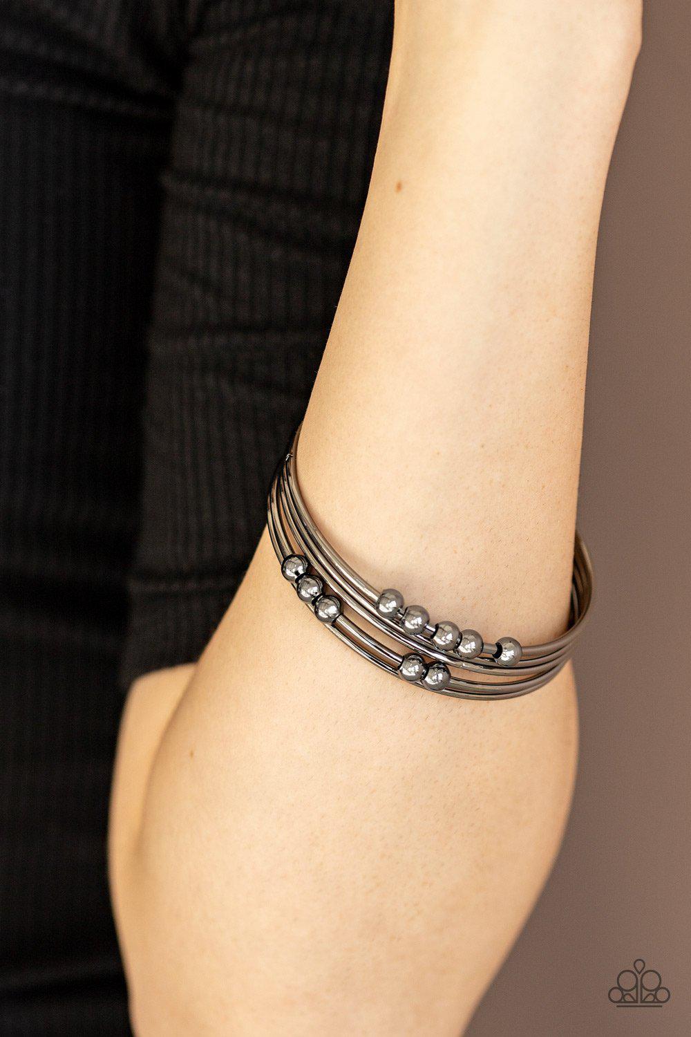 Stack Challenge Gunmetal Black Bangle Bracelet Set - Paparazzi Accessories- on model - CarasShop.com - Paparazzi Jewelry by Cara Jewels