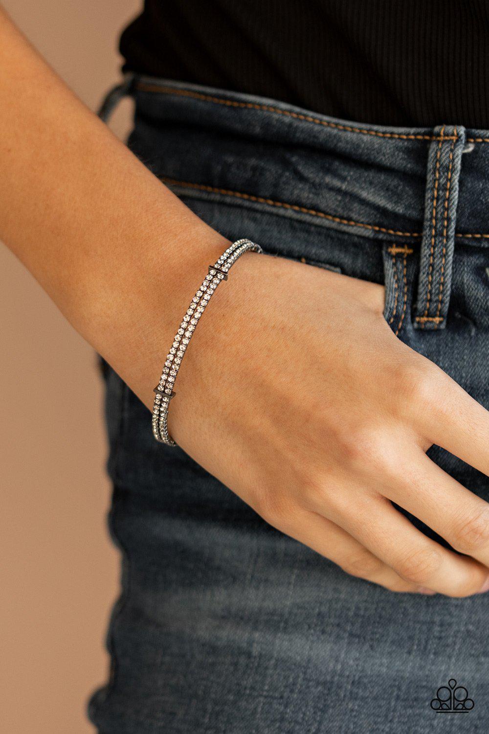 Standout Opulence Gunmetal Black and White Rhinestone Bangle Bracelet - Paparazzi Accessories- on model - CarasShop.com - Paparazzi Jewelry by Cara Jewels