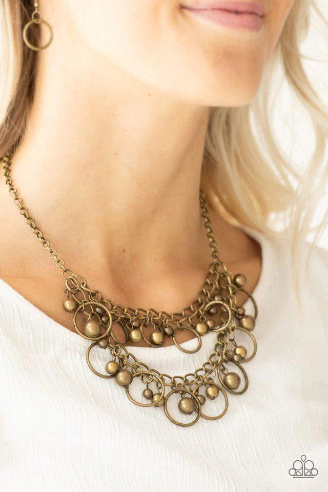 Warning Bells Brass Necklace - Paparazzi Accessories- on model - CarasShop.com - Paparazzi Jewelry by Cara Jewels